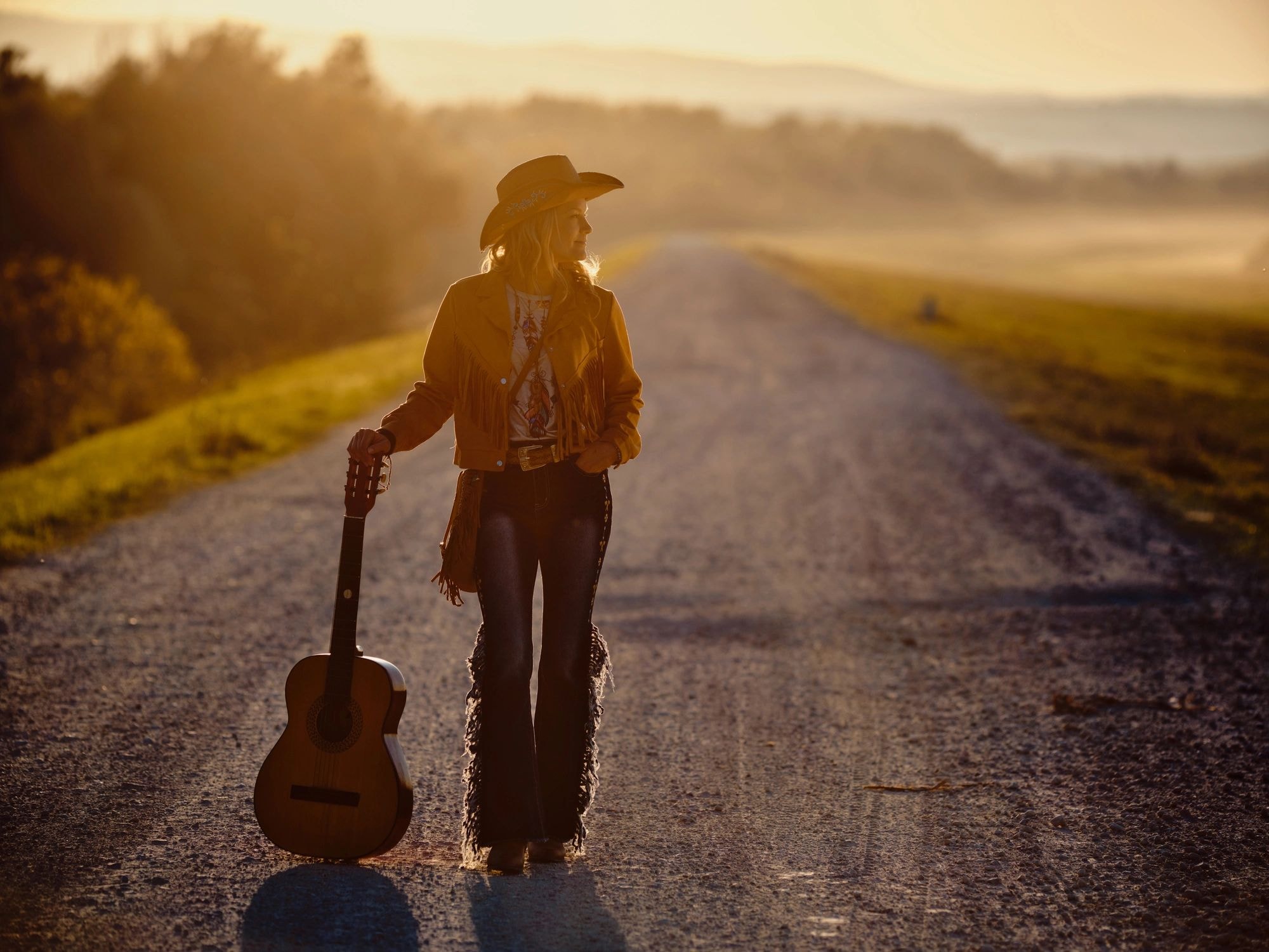 Cowboy musician on rural road